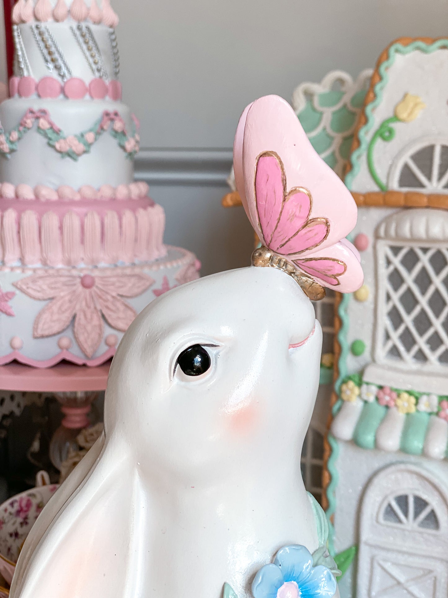 Bespoke Hand Painted White Easter Bunny with Pastel Blue Flowers and a Pink and Gold Butterfly