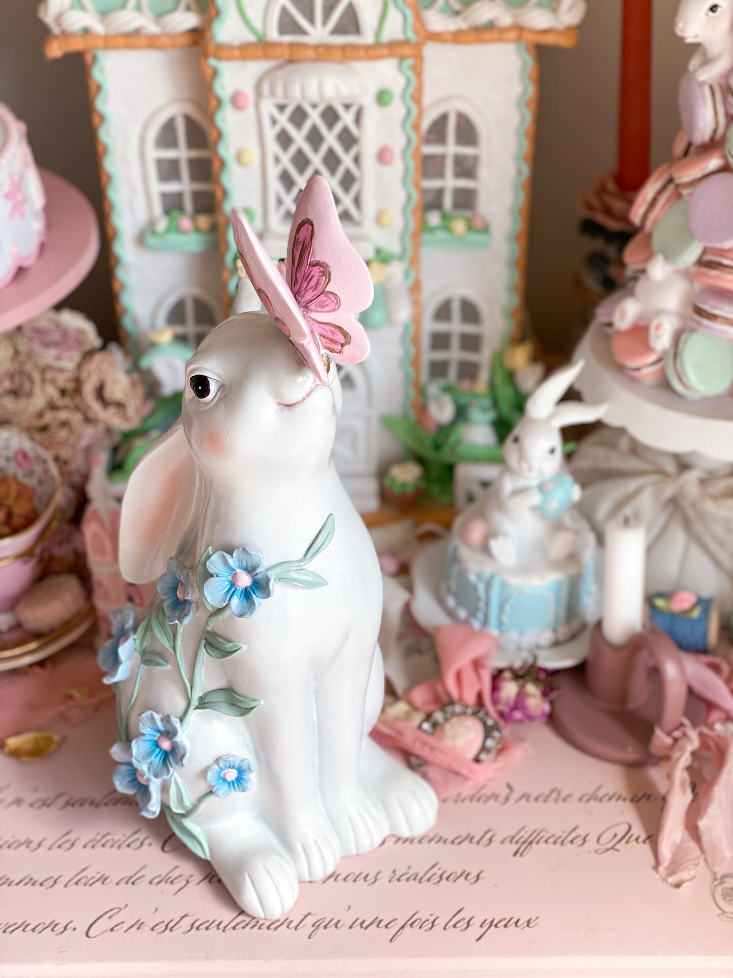 Bespoke Hand Painted White Easter Bunny with Pastel Blue Flowers and a Pink and Gold Butterfly