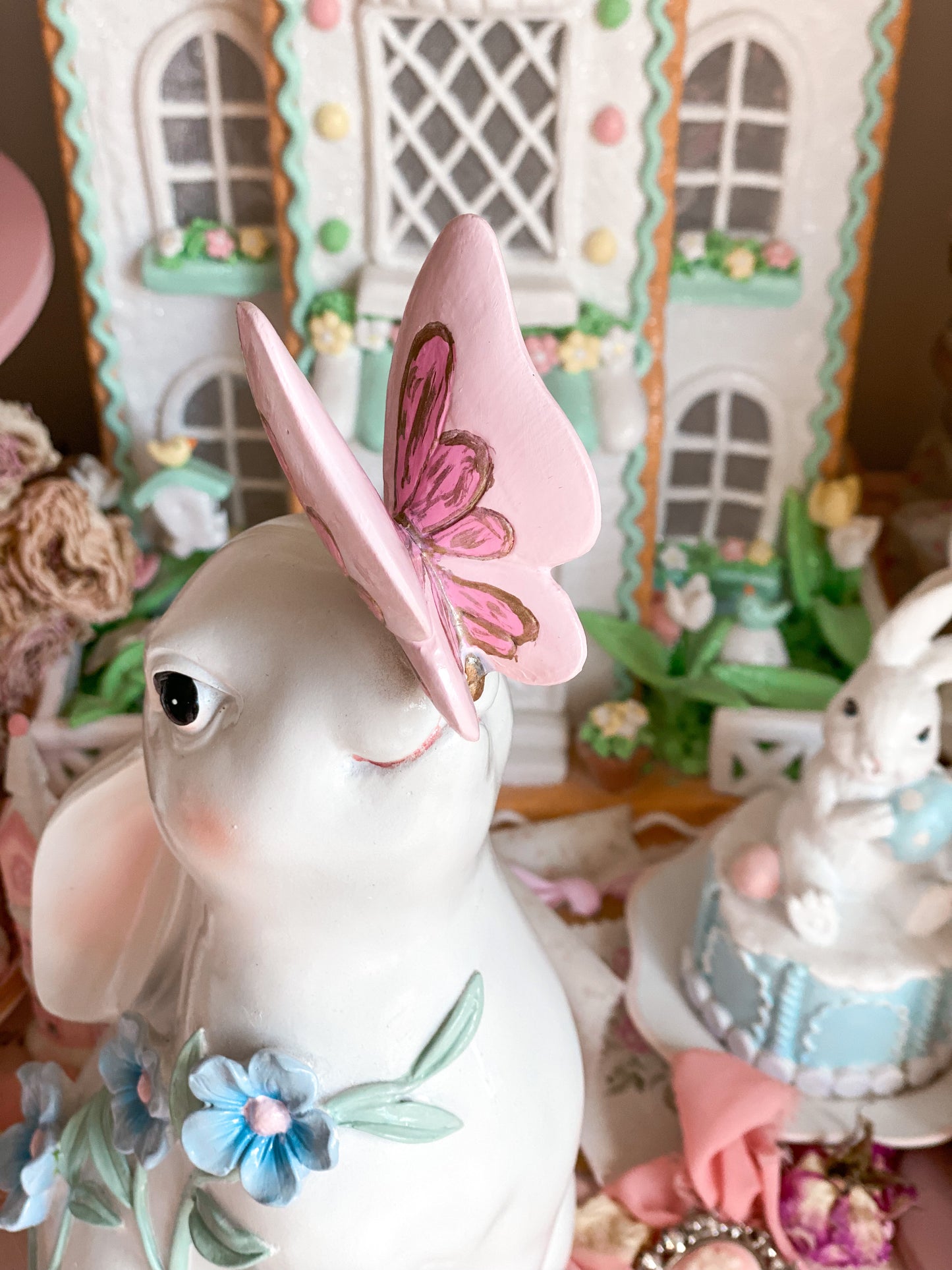 Bespoke Hand Painted White Easter Bunny with Pastel Blue Flowers and a Pink and Gold Butterfly