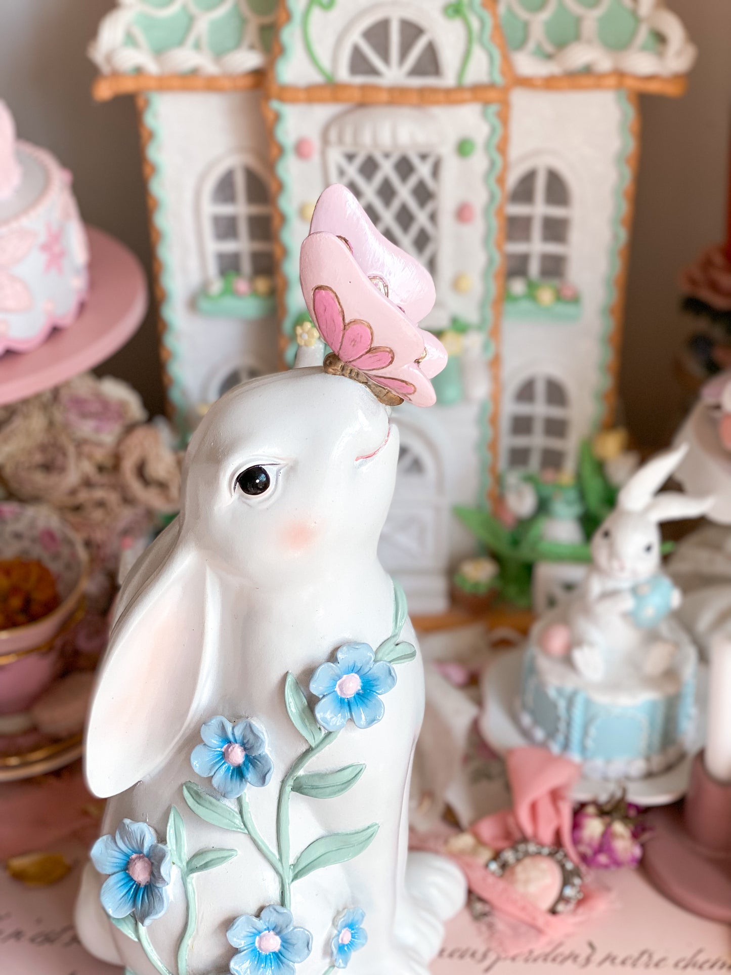 Bespoke Hand Painted White Easter Bunny with Pastel Blue Flowers and a Pink and Gold Butterfly