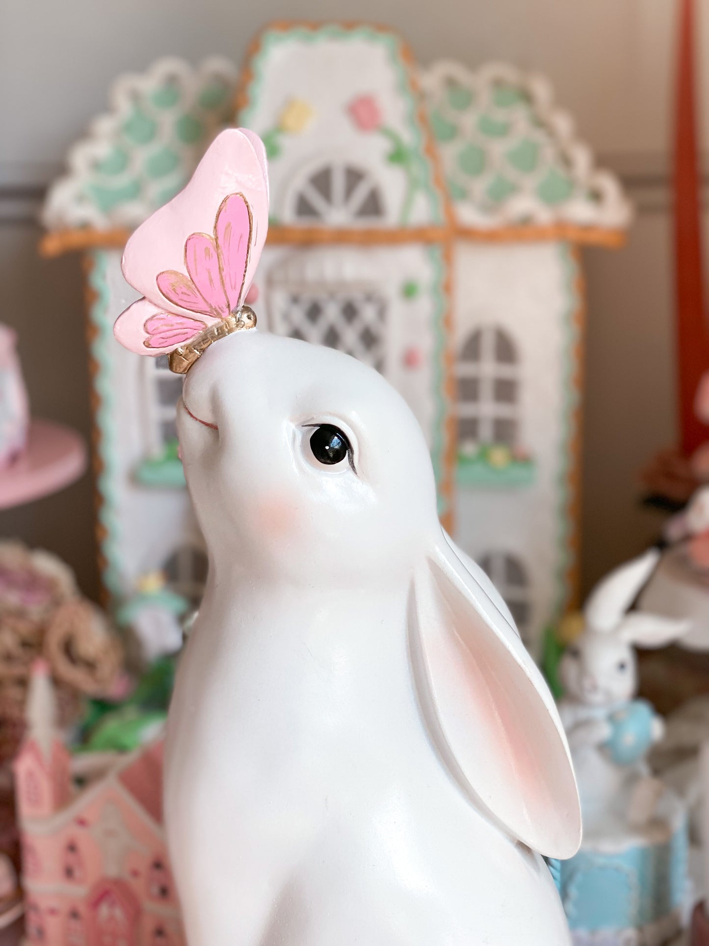 Bespoke Hand Painted White Easter Bunny with Pastel Blue Flowers and a Pink and Gold Butterfly