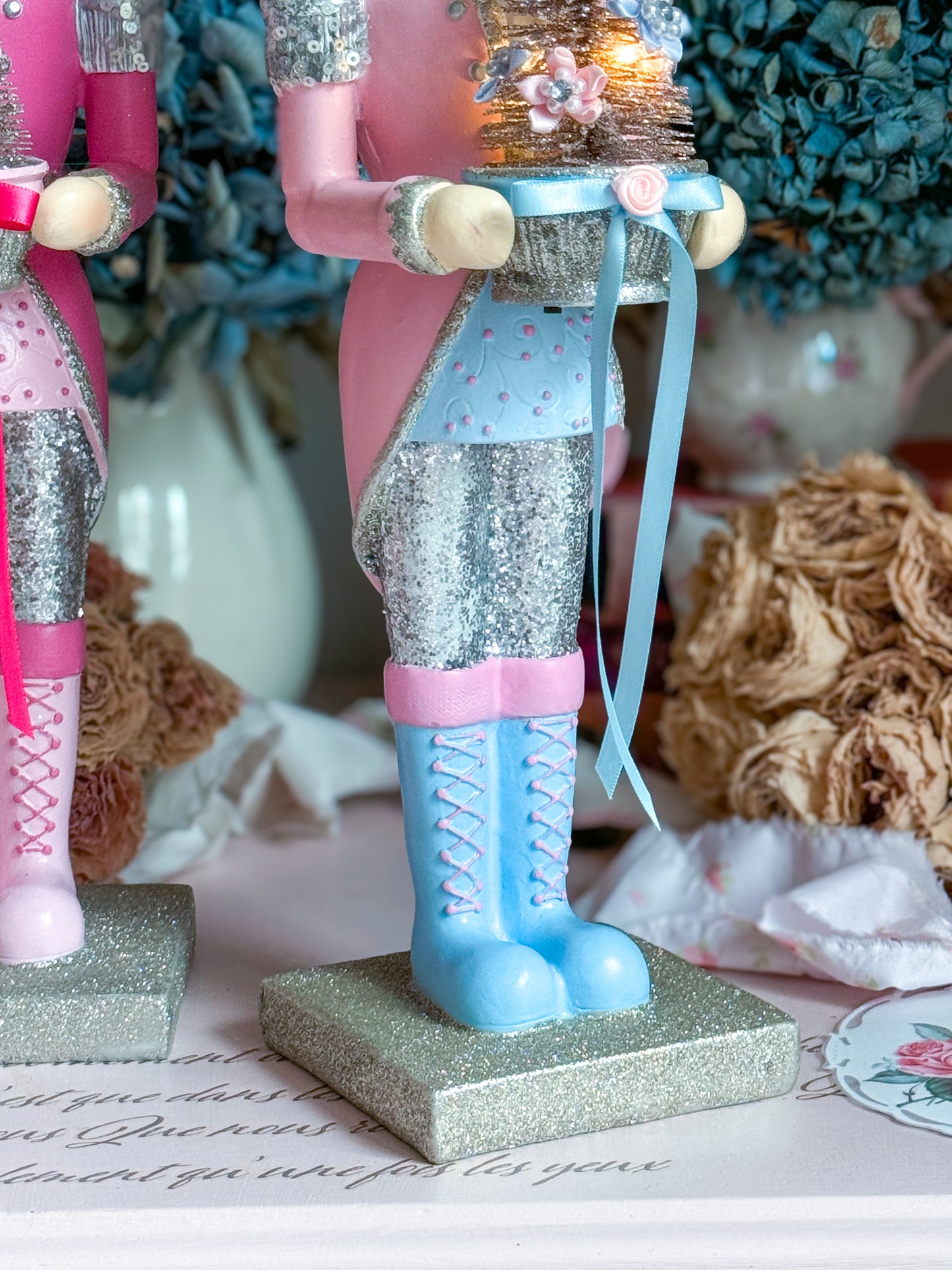 Bespoke Pastel Pink, Blue and Silver Hand Painted Nutcracker holding LED Light up Tree with Flowers and Bows