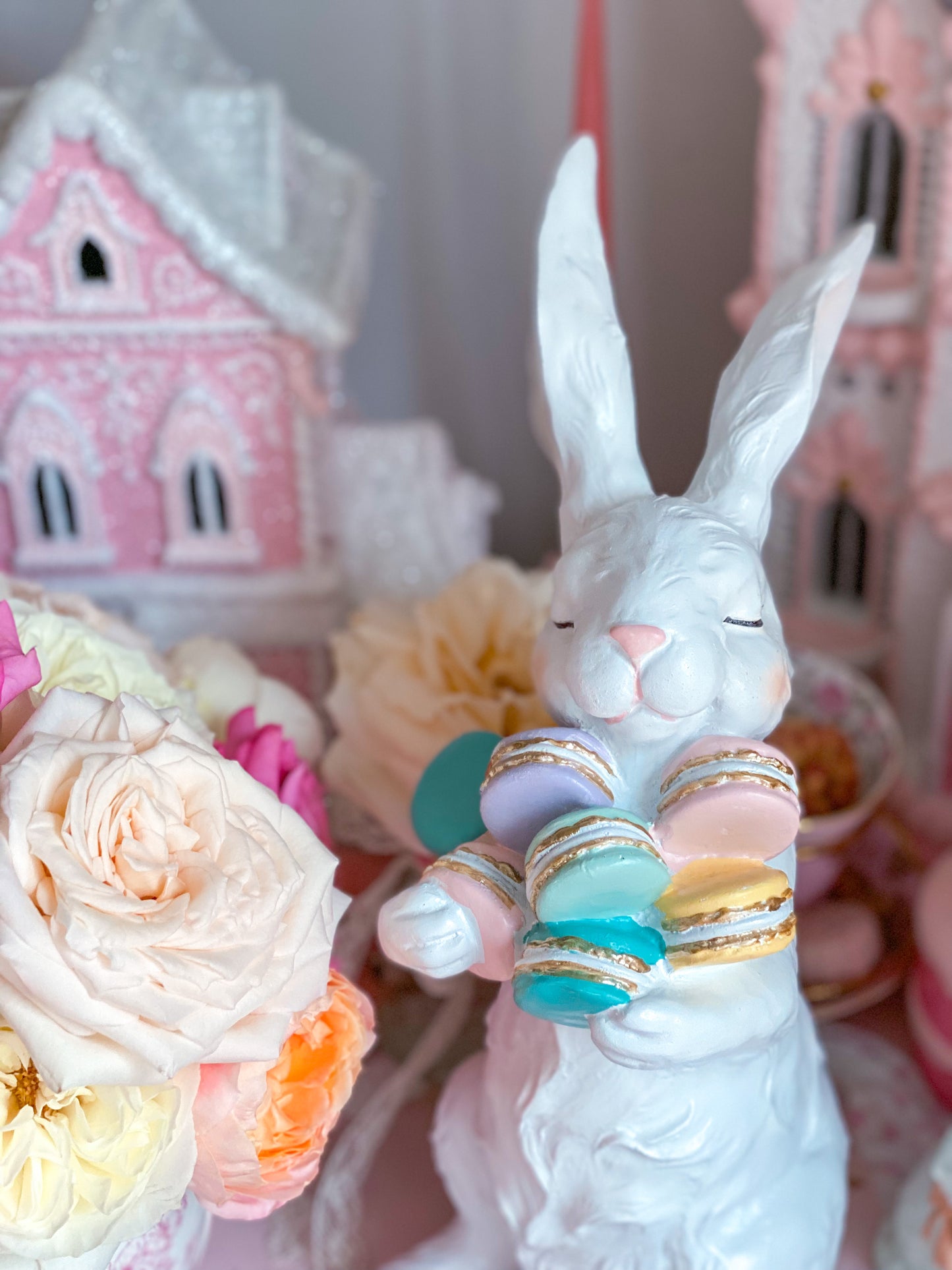 Easter Bunny Figurine holding Pastel Pink, Green, Blue and Purple Macarons