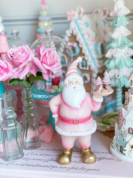Papá Noel rosa pastel sosteniendo bandeja de pastelería