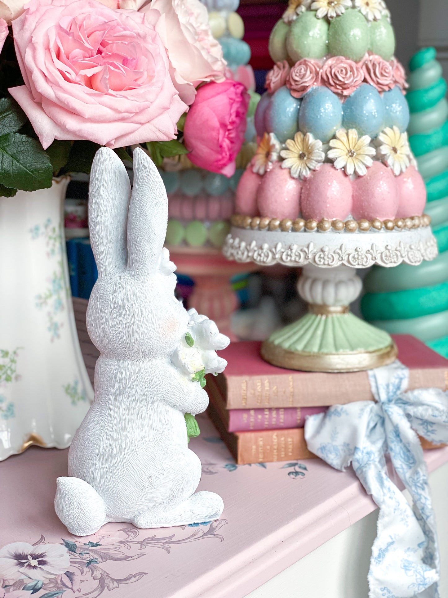 Easter Bunny Figurine sniffing Pastel Pink Blue and Purple Flowers