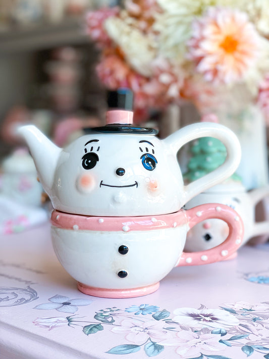 Taza y tetera con muñeco de nieve en rosa pastel de Johanna Parker